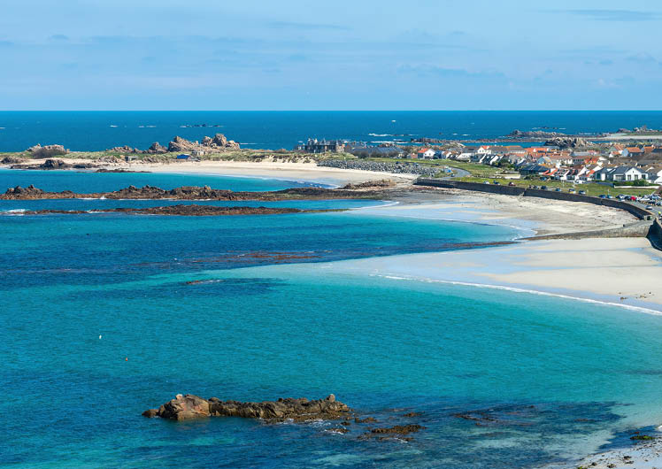 Aerial panoramic view of Cobo Bay, sandy beach landscape panorama in Guernsey, Channel Islands web banner