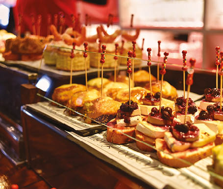 Tapas on Crusty Bread - Selection of Spanish tapas served on a sliced baguette