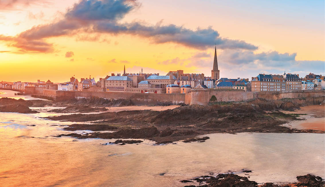 Walled city Saint-Malo with St Vincent Cathedral at sunrise at high tide. Saint-Maol is famous port city of Privateers is known as city corsaire, Brittany, France