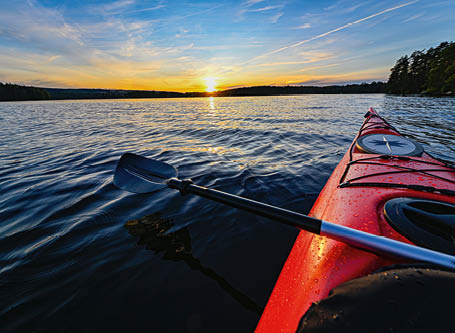 red plastic kayak on calm water in the sunset Filipstad july 31 2019